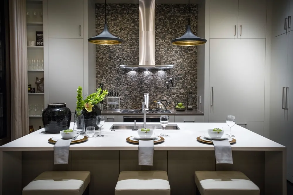 Kitchen with a long island, pendant lights and tile backsplash